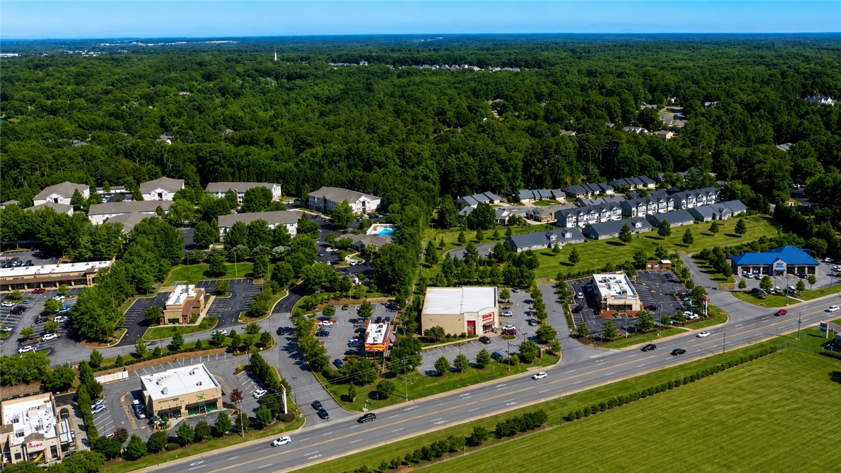 102 Ventura Street Anderson, SC 29621 - Photo 23 of 24 An aerial perspective reveals a vibrant mixed-use community with residences, businesses, and ample green space.