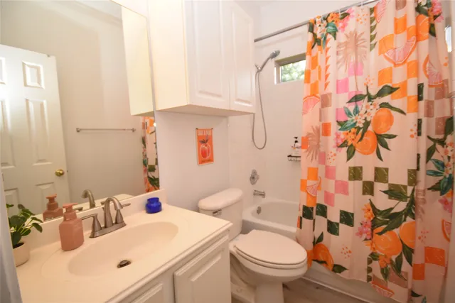 a bedroom with a bed and a flat tv screen on a dresser