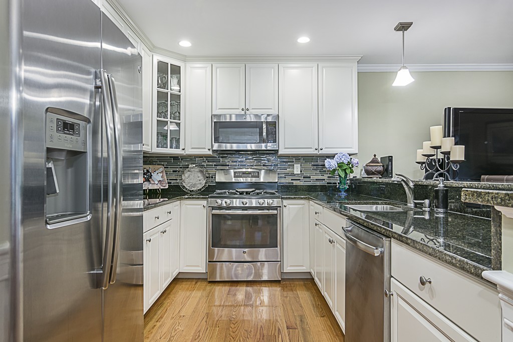 6 Robinson Road, Unit 16 Lexington, MA 02420 - Photo 9 of 20 a kitchen with stainless steel appliances granite countertop a refrigerator a stove and a sink