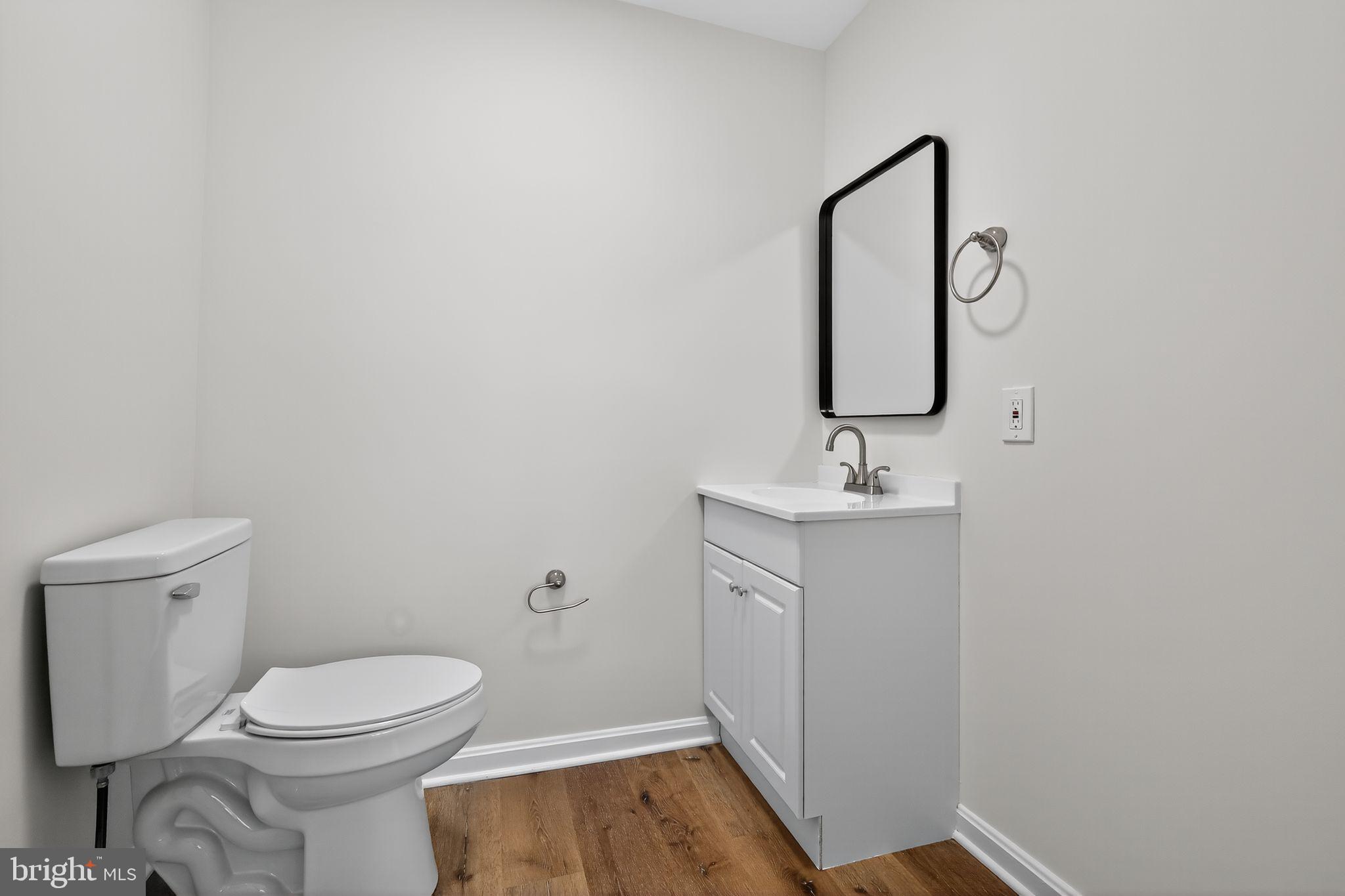 4508 Yates Road Beltsville, MD 20705 - Photo 17 of 25 a bathroom with a toilet sink and mirror