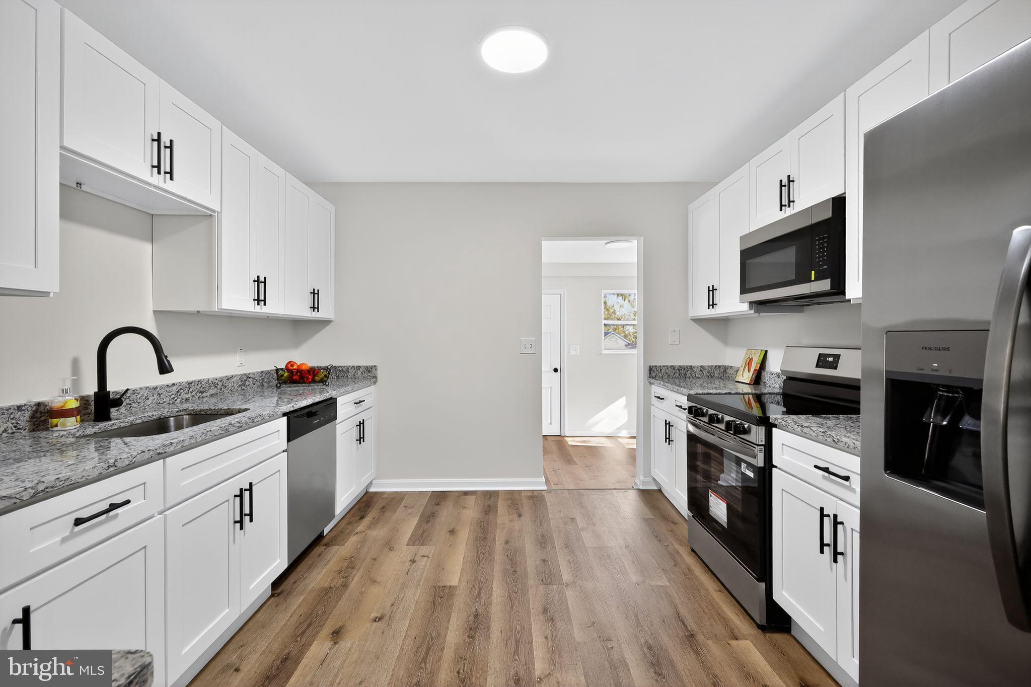 4508 Yates Road Beltsville, MD 20705 - Photo 2 of 25 a view of a kitchen with sink stove and refrigerator