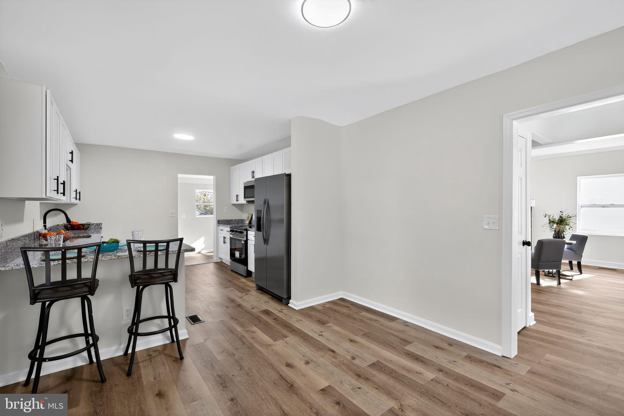 4508 Yates Road Beltsville, MD 20705 - Photo 5 of 25 a view of a dining room with furniture and wooden floor