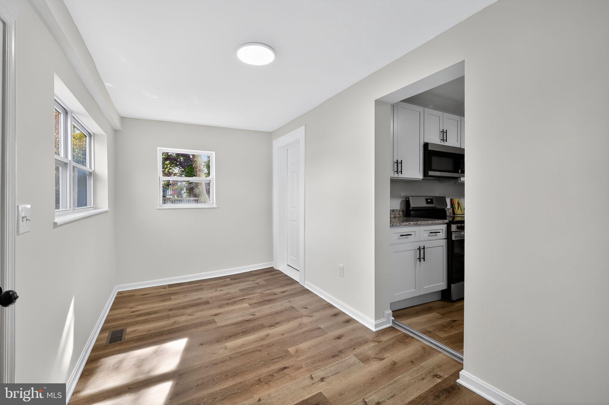 4508 Yates Road Beltsville, MD 20705 - Photo 6 of 25 a view of kitchen and hallway with wooden floor