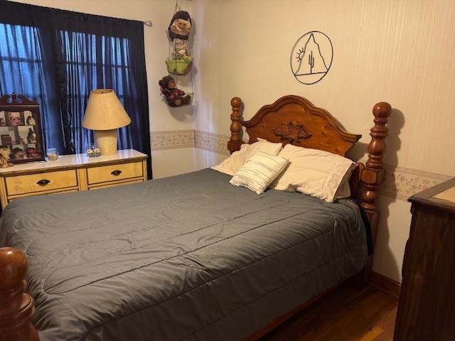 110 Levoid Road Bolivar, TN 38008 - Photo 11 of 22 a bedroom with bed and a chandelier