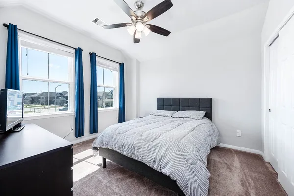 a bedroom with a large bed and a large window