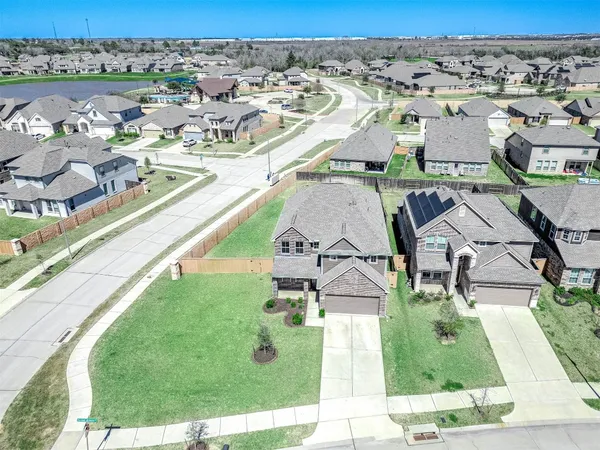 an aerial view of residential houses with outdoor space