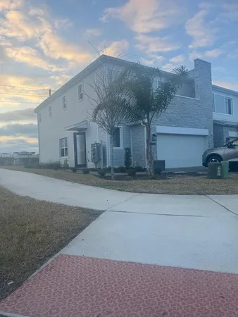 a front view of house along with trees