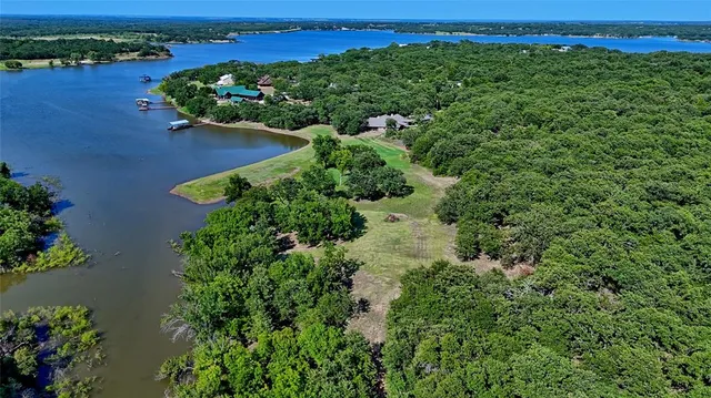 an aerial view of a houses with a yard