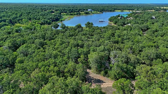 an aerial view of a houses with a yard