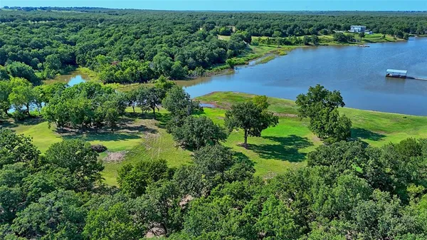 an aerial view of a houses with a yard