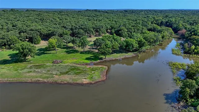 a view of a lake with a yard and mountain