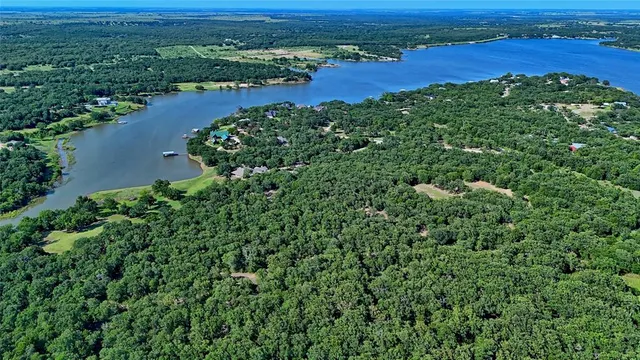 an aerial view of a houses with a yard