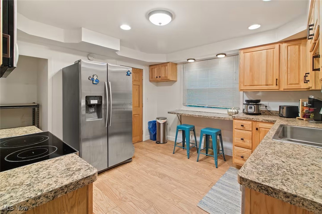 47 Prospect Road Berea, OH 44017 - Photo 9 of 23 Kitchen with stainless steel fridge with ice dispenser, light wood-style floors, light brown cabinets, light countertops, and recessed lighting