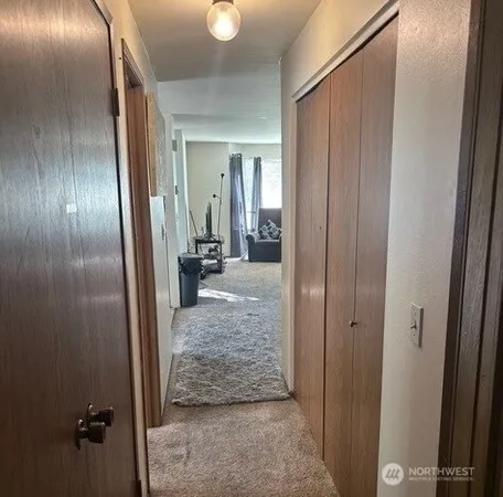 a view of a hallway with wooden floor and staircase