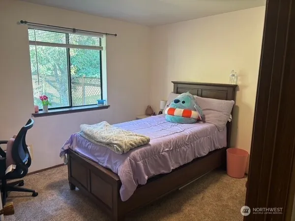 a bedroom with a bed and window