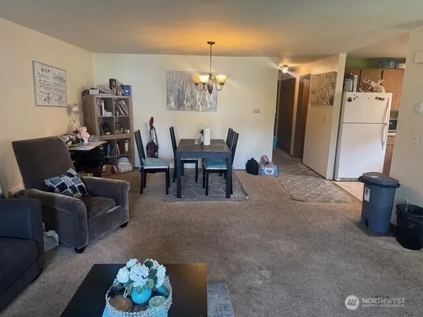 a living room with furniture and a dining table