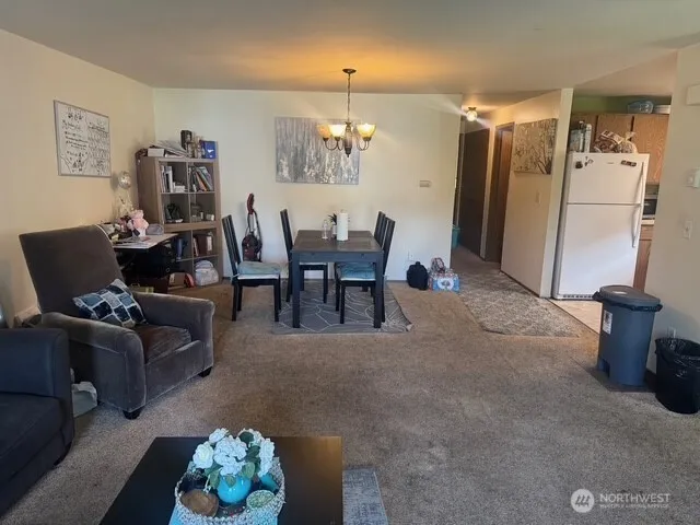 a living room with furniture and a dining table