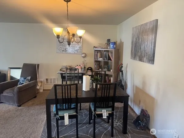 a view of a dining room with furniture and chandelier
