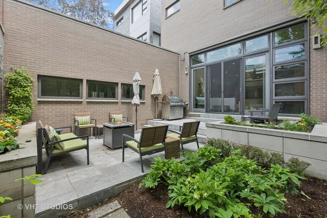 a view of a house with a backyard and sitting area