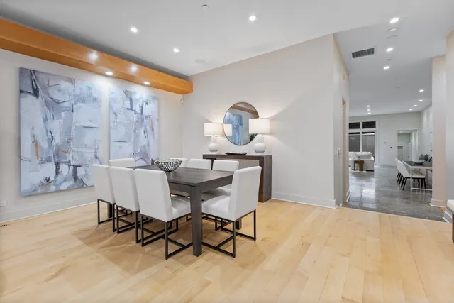 a dining room with furniture and wooden floor