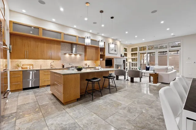 a kitchen with a sink a counter top space appliances and cabinets