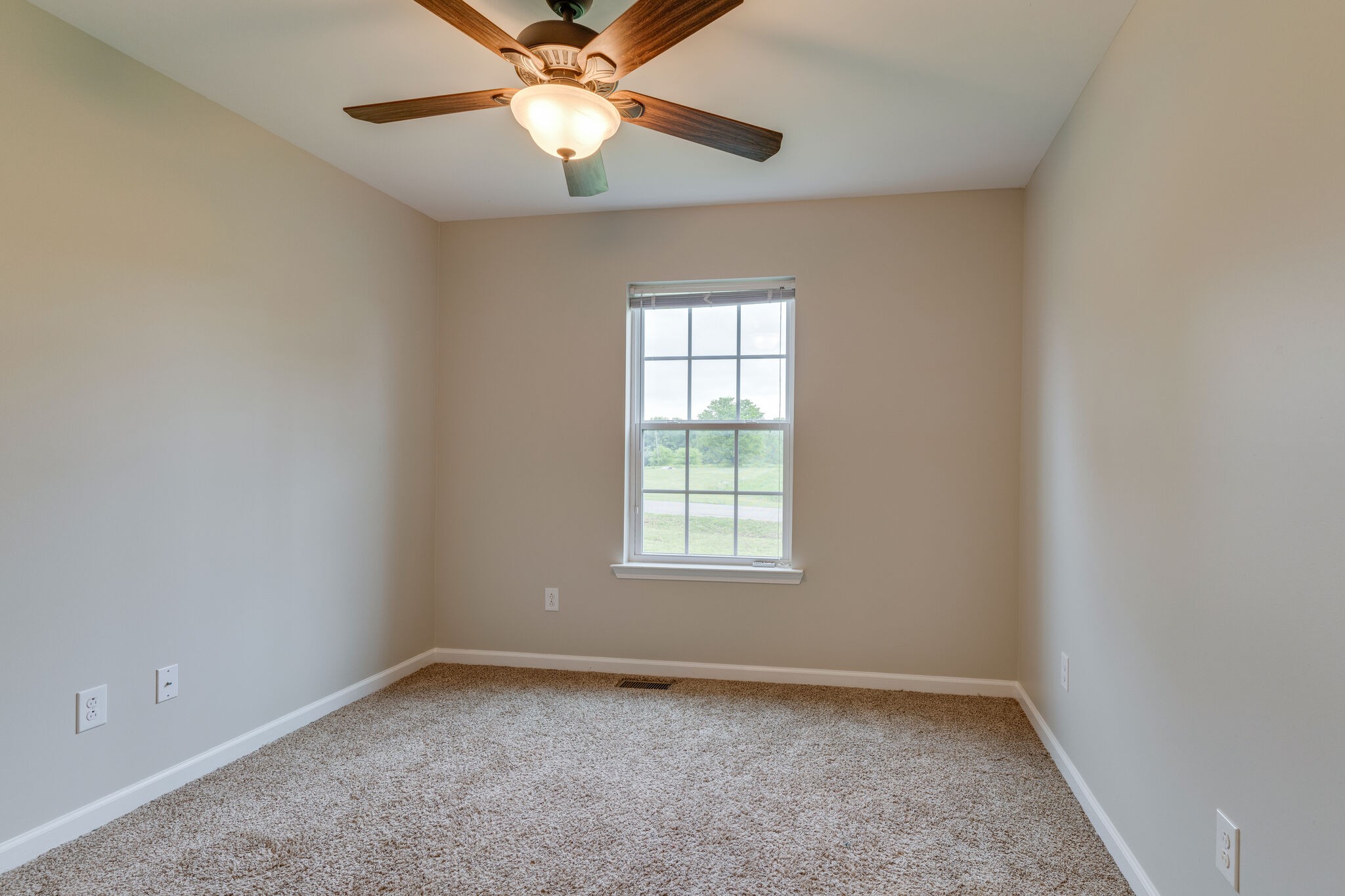 202 Shaub Road Portland, TN 37148 - Photo 15 of 25 an empty room with a window and a fan