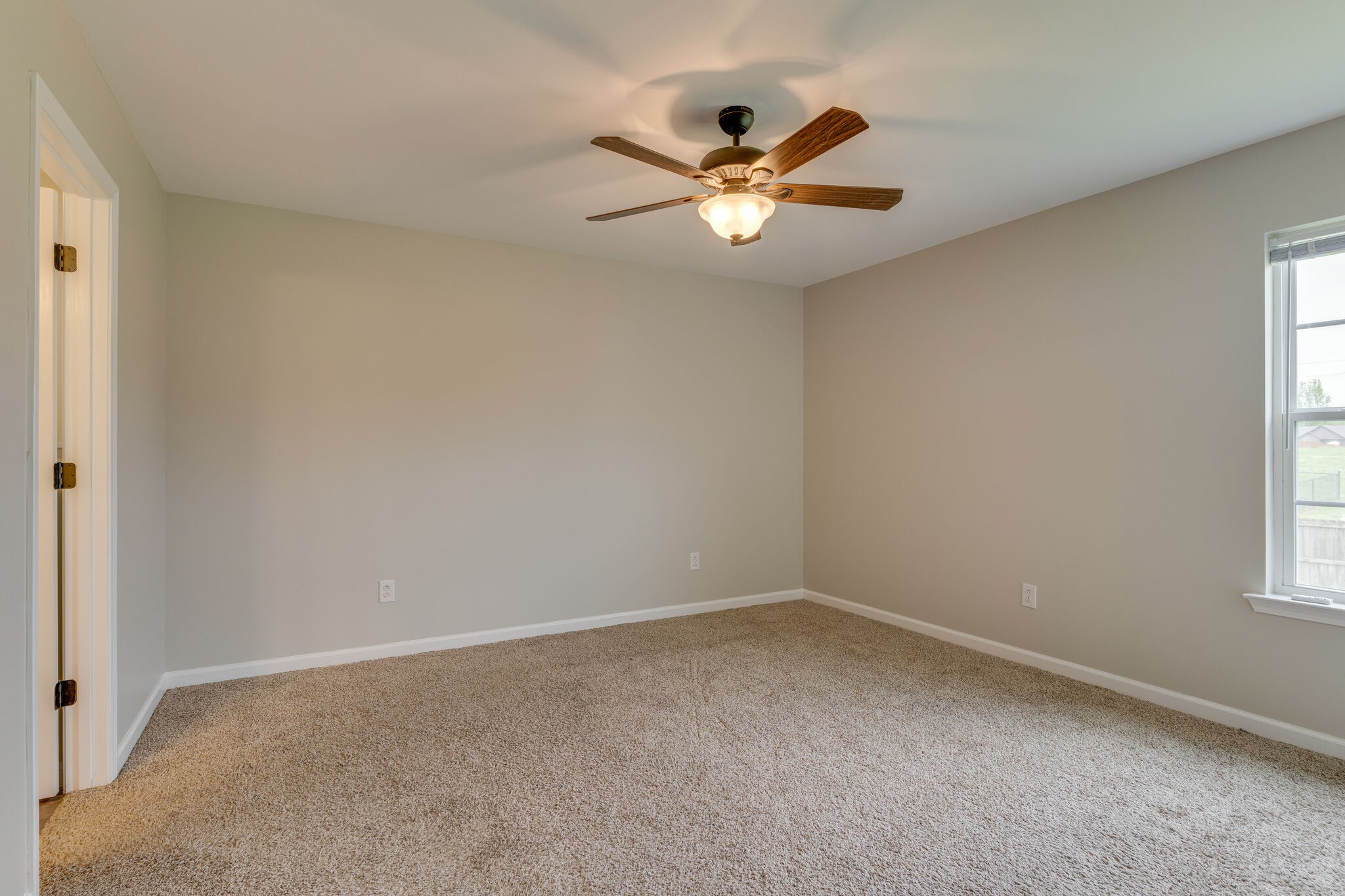 202 Shaub Road Portland, TN 37148 - Photo 9 of 25 an empty room with windows and fan