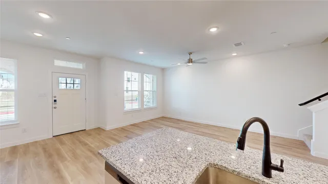 a view of a sink and dishwasher with wooden floor