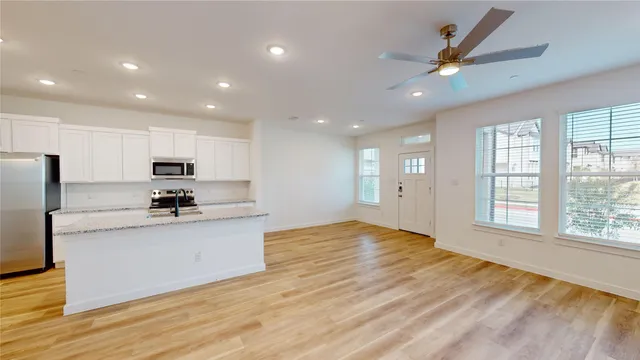 a large kitchen with stainless steel appliances granite countertop a large counter top and a stove