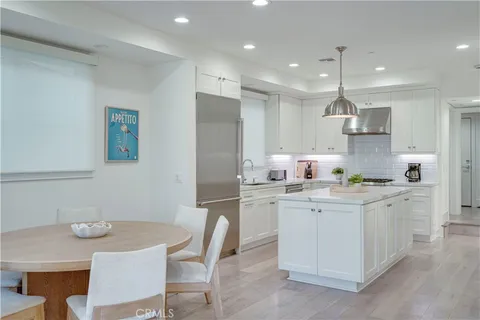 a kitchen with a sink a refrigerator and cabinets