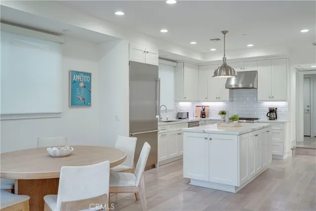 a kitchen with a sink a refrigerator and cabinets
