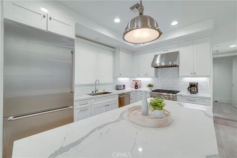 a kitchen with a stove sink and cabinets