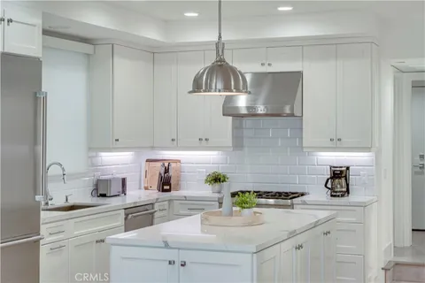 a stove top oven sitting inside of a kitchen