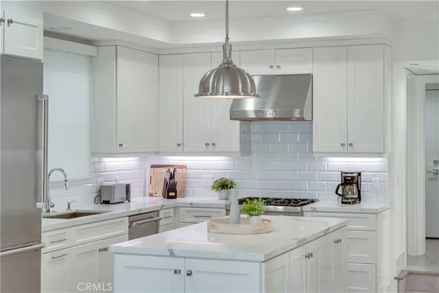 a stove top oven sitting inside of a kitchen