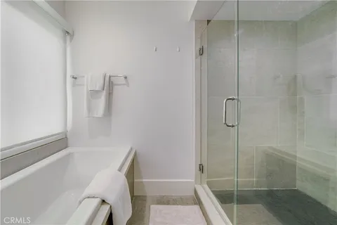 a bathroom with a granite countertop sink a toilet a mirror and shower