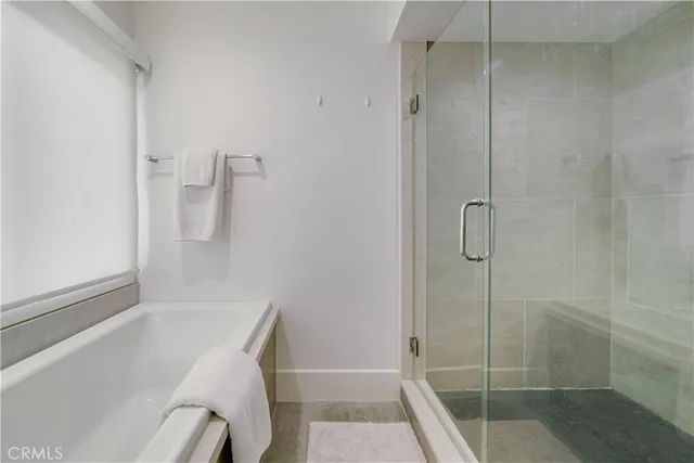 a bathroom with a granite countertop sink a toilet a mirror and shower
