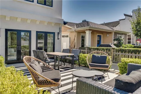 a view of a patio with table and chairs and potted plants