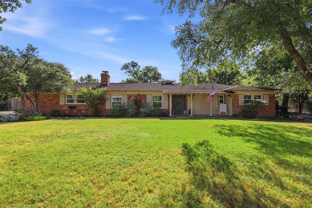 103 Paint Brush Road Lakeside, TX 76108 - Photo 1 of 24 a front view of a house with a garden