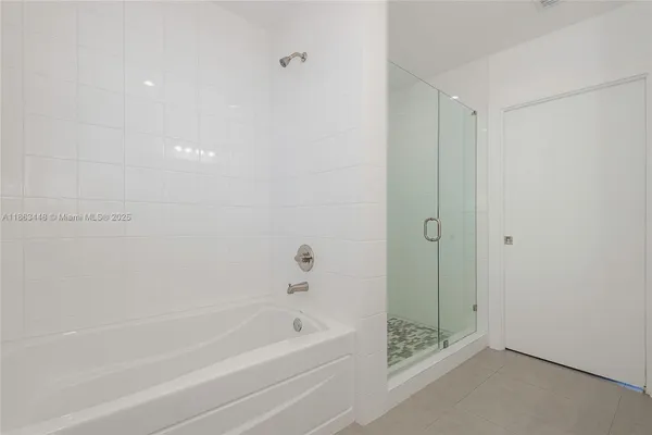 a bathroom with a bathtub and a shower