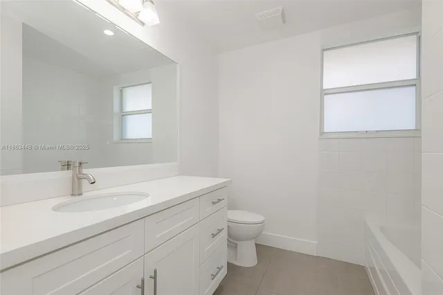a bathroom with a sink toilet and vanity