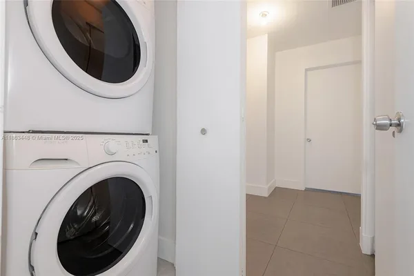 a view of a hallway with washer and dryer