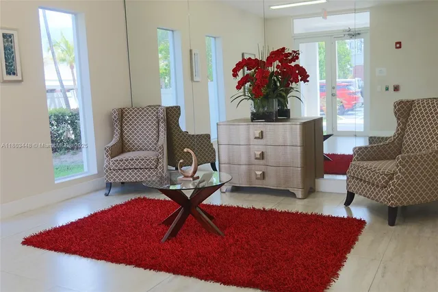 a living room with furniture and a potted plant