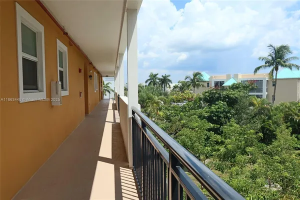 a view of balcony with wooden floor and fence