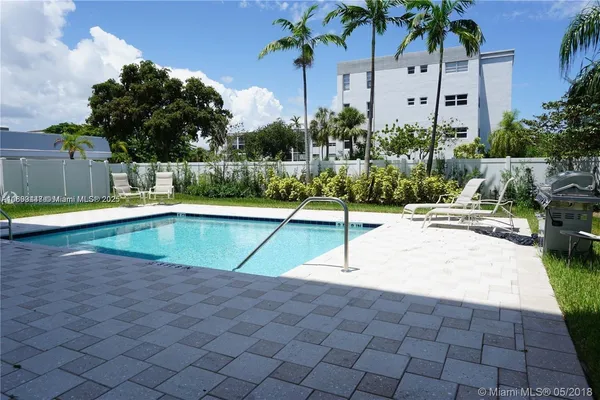 a swimming pool with outdoor seating and yard