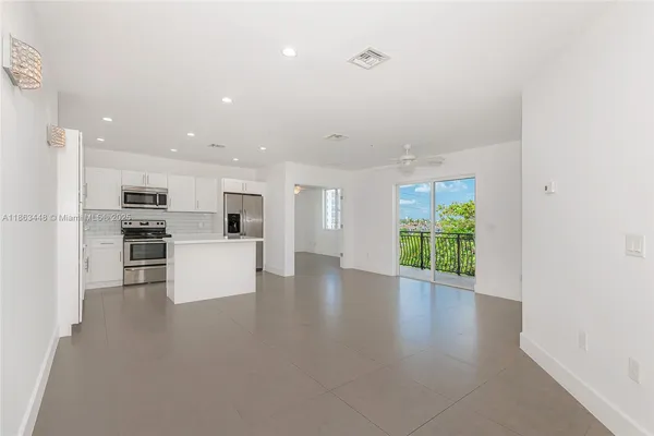 a view of kitchen with furniture and refrigerator