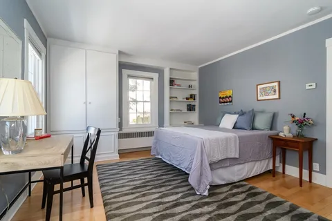 a bedroom with a bed and a table in it