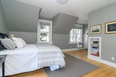 a bedroom with a bed and window