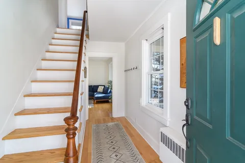 a view of entryway with stairs and wooden floor