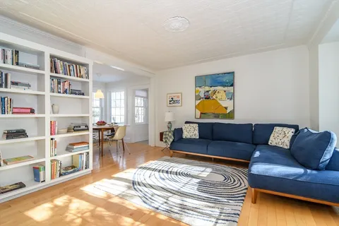 a living room with furniture and a book shelf