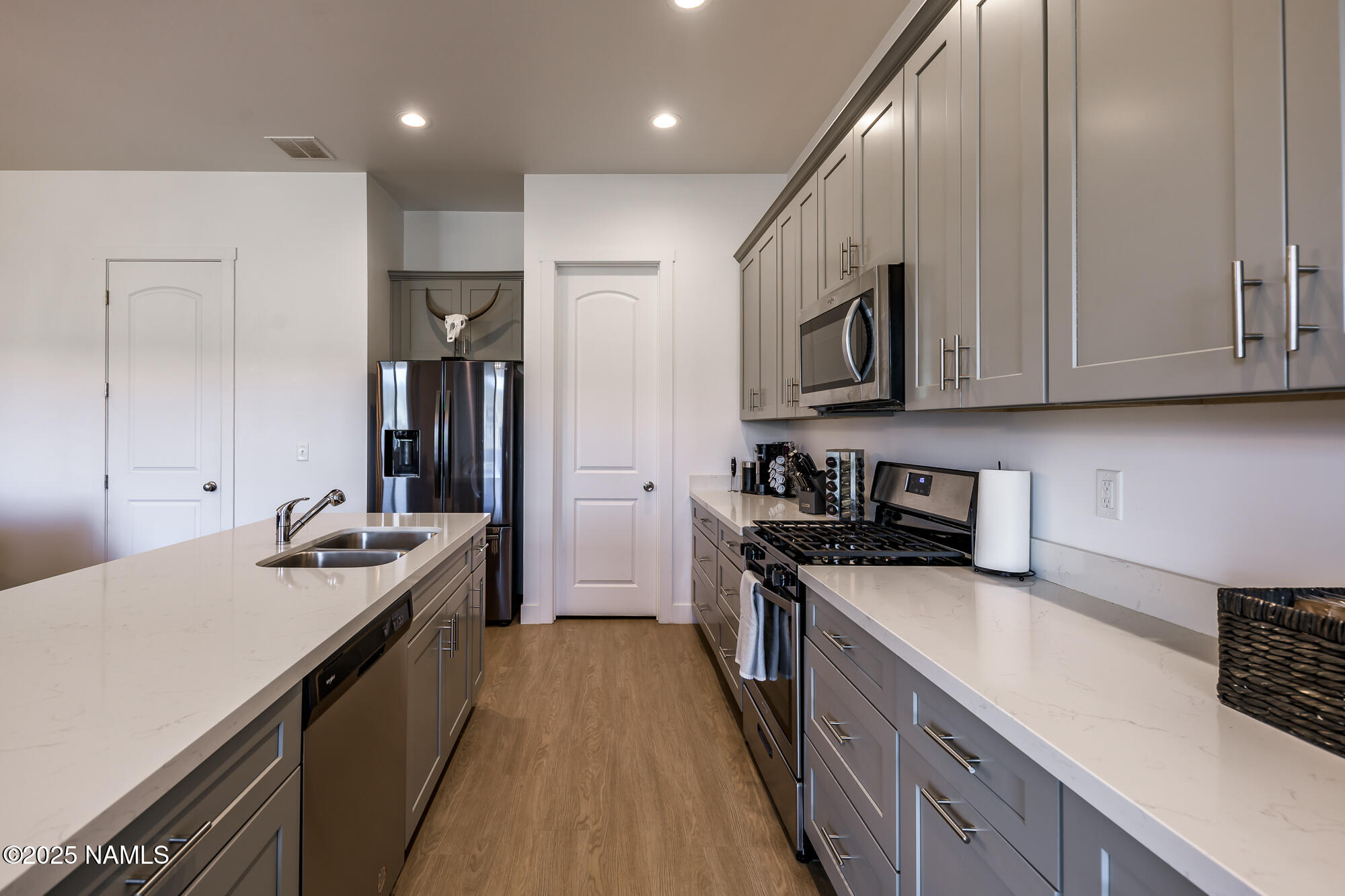 11780 Pegasus Road Bellemont, AZ 86015 - Photo 17 of 44 a kitchen with stainless steel appliances granite countertop a sink stove and refrigerator